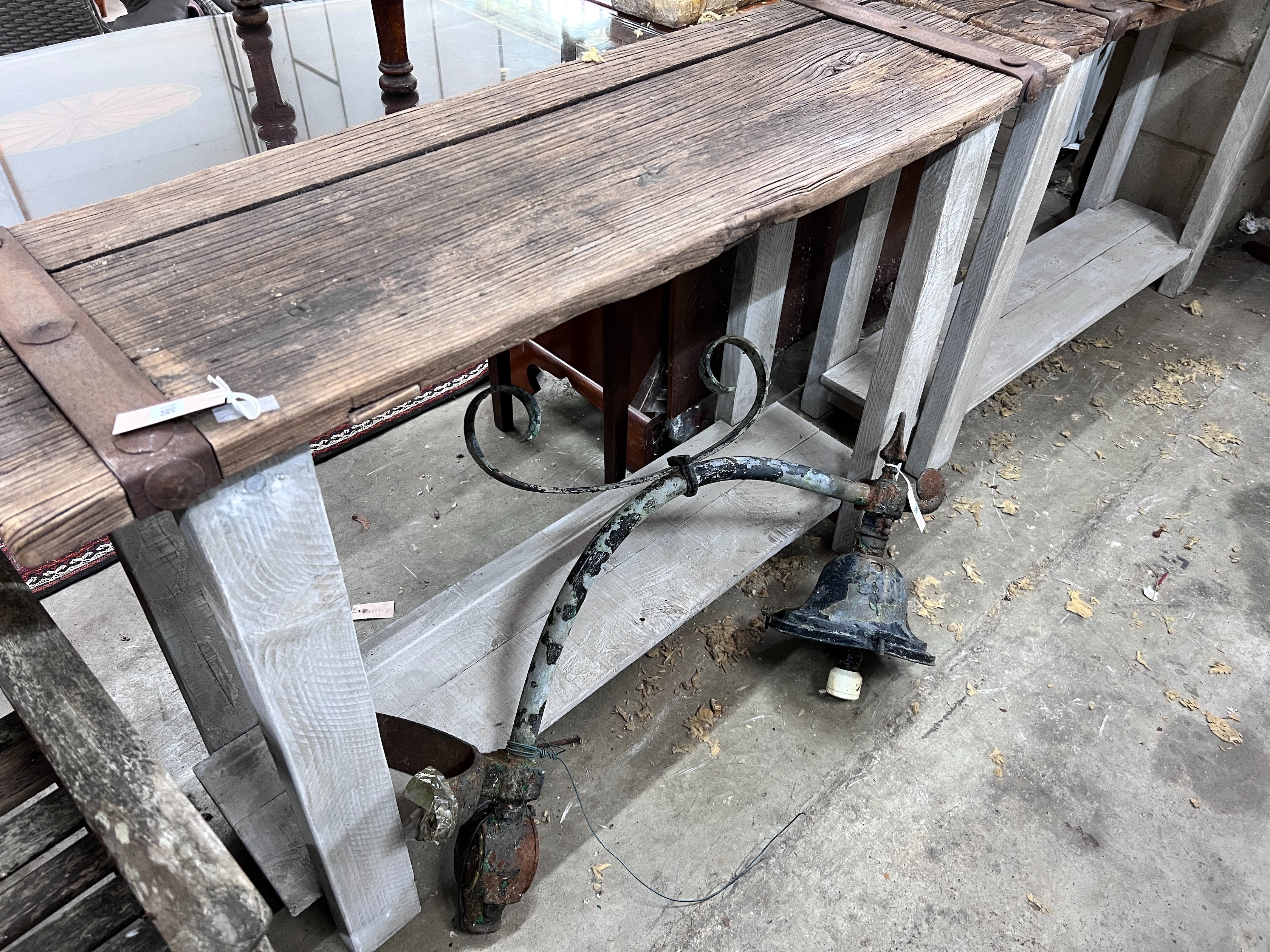 A pair of stained oak console tables with iron bound raw wood tops, width 132cm, depth 40cm, height 87cm *Please note the sale commences at 9am.
